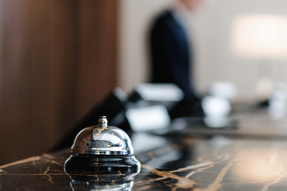 Silver hotel bell at the reception desk