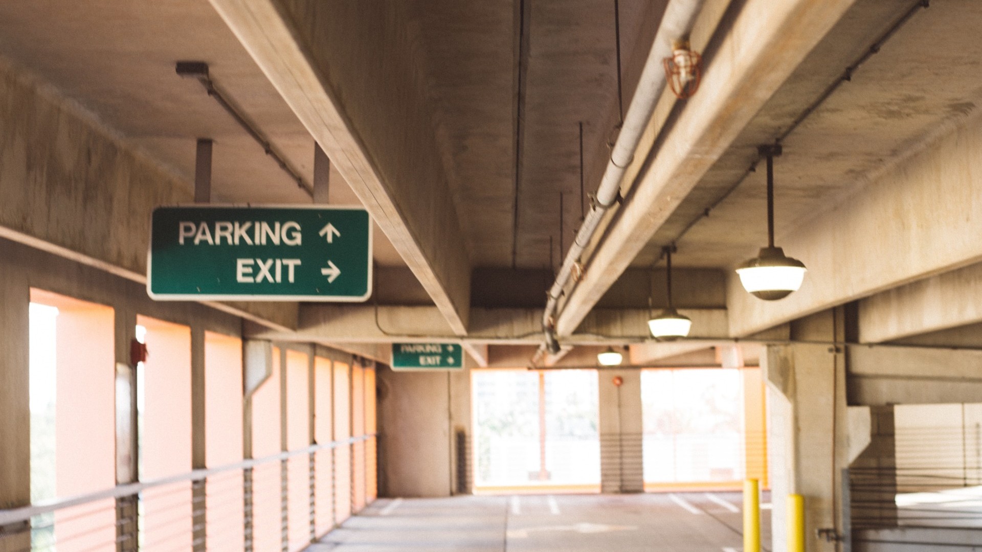 Empty parking garage with direction signs.