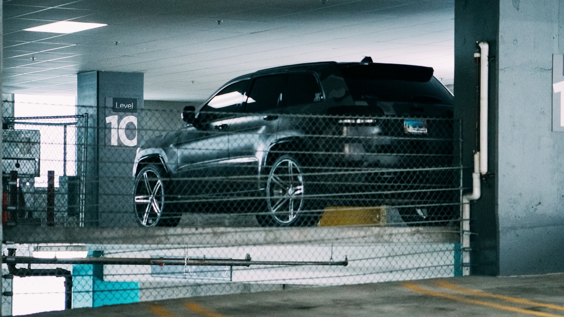 A car parked in a large parking garage